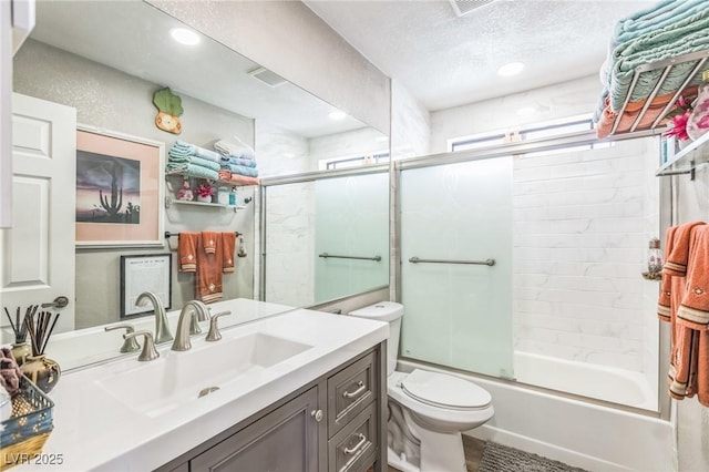 2111 River City Dr, Laughlin, NV 89029 - full bath featuring enclosed tub / shower combo, toilet, vanity, a textured ceiling, and recessed lighting