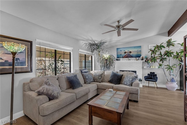 2111 River City Dr, Laughlin, NV 89029 - living area featuring ceiling fan, a brick fireplace, wood finished floors, baseboards, and lofted ceiling