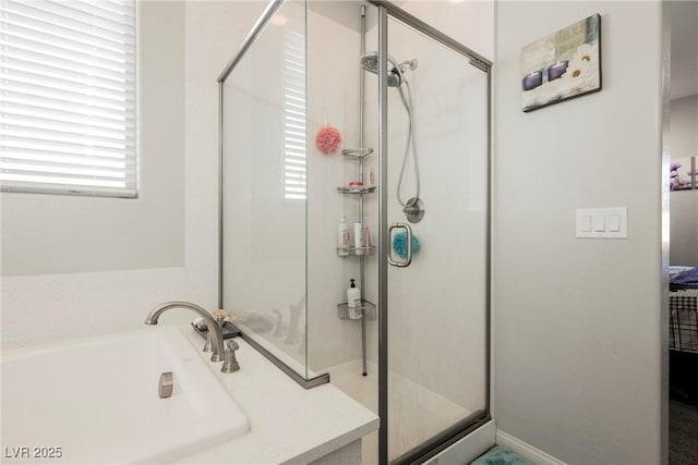 full bath with a sink and a shower stall