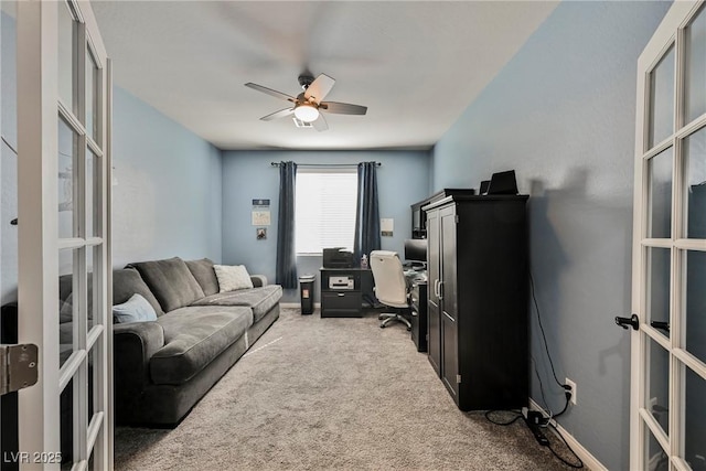 carpeted living room with french doors and a ceiling fan