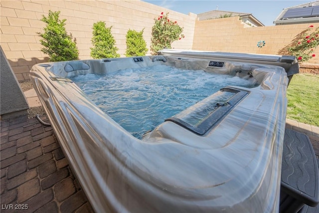 view of pool featuring a hot tub and fence