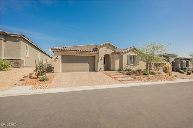 10126 Cliff Dwellings Ave, Las Vegas, NV 89178 - mediterranean / spanish-style house with an attached garage, stucco siding, driveway, and a tiled roof