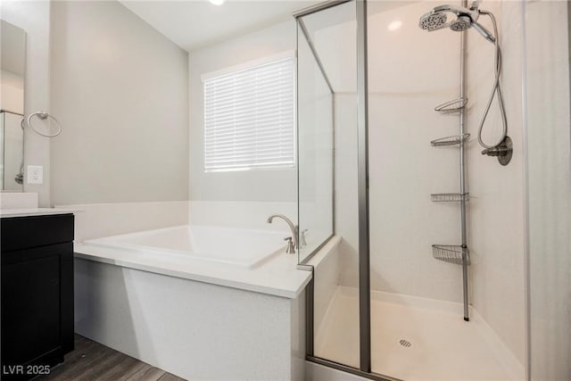10126 Cliff Dwellings Ave, Las Vegas, NV 89178 - full bath featuring a shower stall, vanity, a garden tub, and wood finished floors