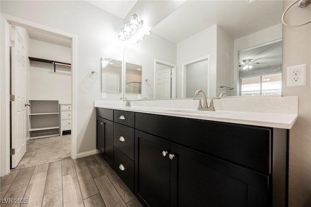 10126 Cliff Dwellings Ave, Las Vegas, NV 89178 - full bath featuring double vanity, wood finished floors, a spacious closet, and a ceiling fan