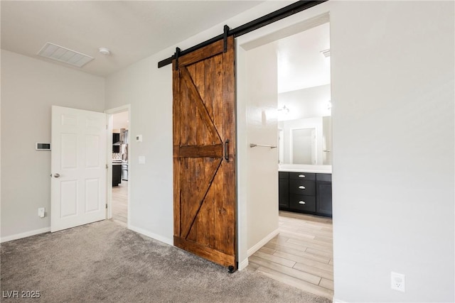 10126 Cliff Dwellings Ave, Las Vegas, NV 89178 - unfurnished bedroom with a barn door and ensuite bath