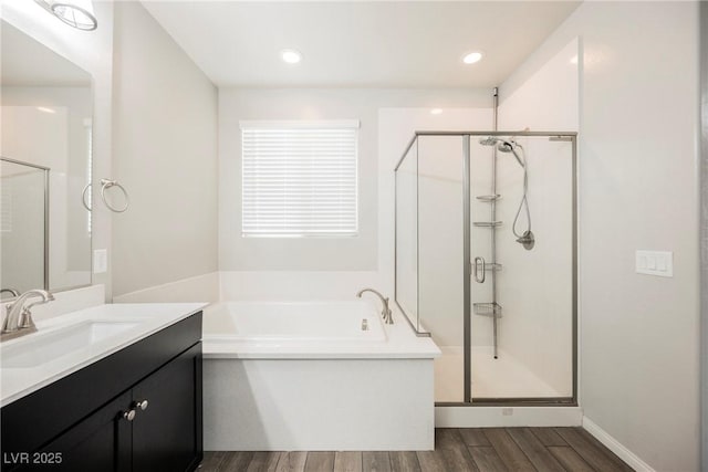 10126 Cliff Dwellings Ave, Las Vegas, NV 89178 - full bath with wood finished floors, a stall shower, vanity, and a bath