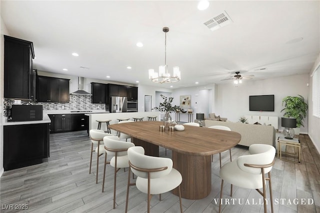 10126 Cliff Dwellings Ave, Las Vegas, NV 89178 - dining room featuring light wood-style floors, ceiling fan, recessed lighting, and a chandelier