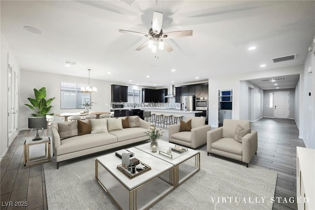 10126 Cliff Dwellings Ave, Las Vegas, NV 89178 - living room featuring light wood finished floors, a ceiling fan, recessed lighting, and a chandelier