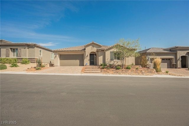 10126 Cliff Dwellings Ave, Las Vegas, NV 89178 - mediterranean / spanish house with a garage, stucco siding, driveway, and stone siding