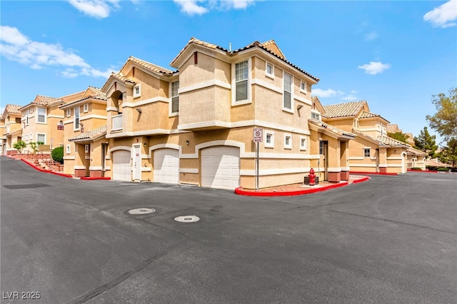 5855 Valley Dr Unit 1101, North Las Vegas, NV 89031 - exterior space featuring stucco siding, a tile roof, a residential view, and an attached garage