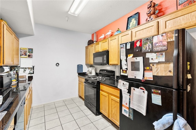 5855 Valley Dr Unit 1101, North Las Vegas, NV 89031 - kitchen with light tile patterned flooring, dark countertops, light brown cabinetry, and black appliances