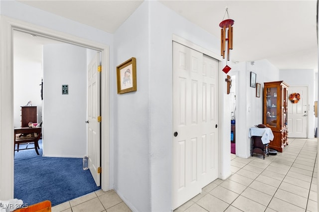 5855 Valley Dr Unit 1101, North Las Vegas, NV 89031 - corridor featuring light carpet, light tile patterned flooring, and baseboards