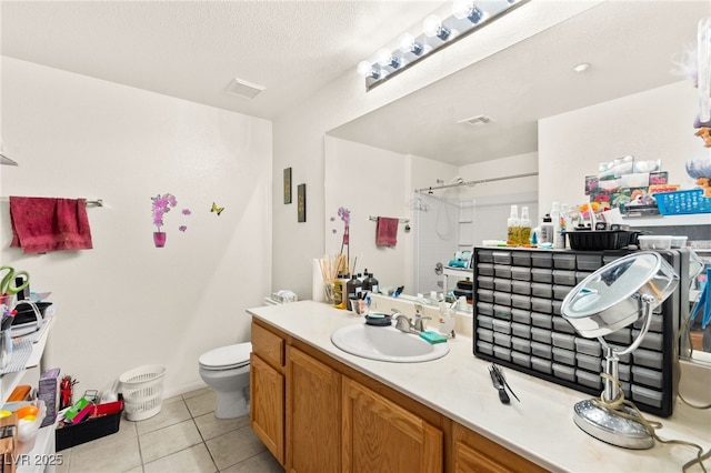 5855 Valley Dr Unit 1101, North Las Vegas, NV 89031 - full bath featuring vanity, walk in shower, toilet, tile patterned flooring, and visible vents