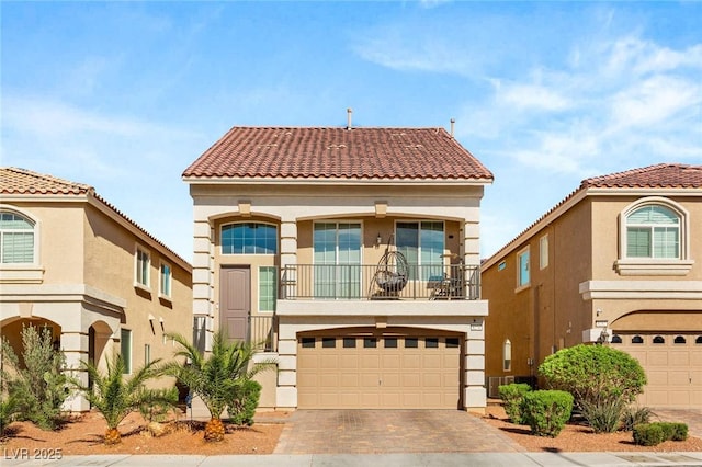8276 Sorrel St, Las Vegas, NV 89139 - mediterranean / spanish home with a balcony, driveway, a tiled roof, a garage, and stucco siding