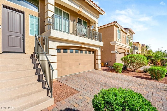 8276 Sorrel St, Las Vegas, NV 89139 - view of front of property with stucco siding, a tile roof, decorative driveway, and a balcony