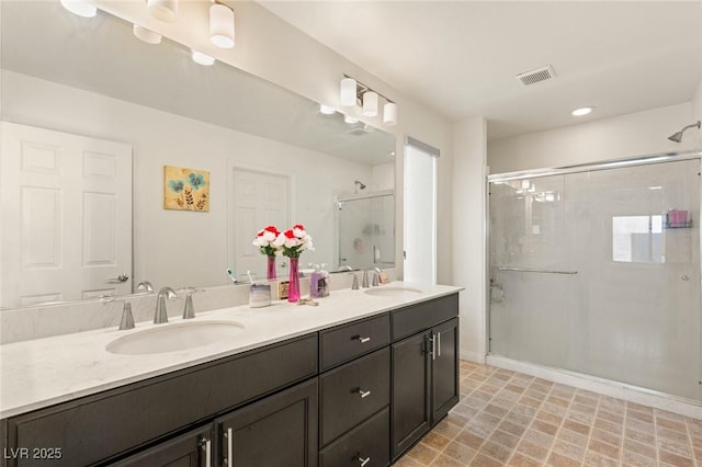 8276 Sorrel St, Las Vegas, NV 89139 - full bath with double vanity, a shower stall, visible vents, and a sink