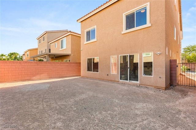 8276 Sorrel St, Las Vegas, NV 89139 - back of property with fence, a tile roof, a patio area, and stucco siding