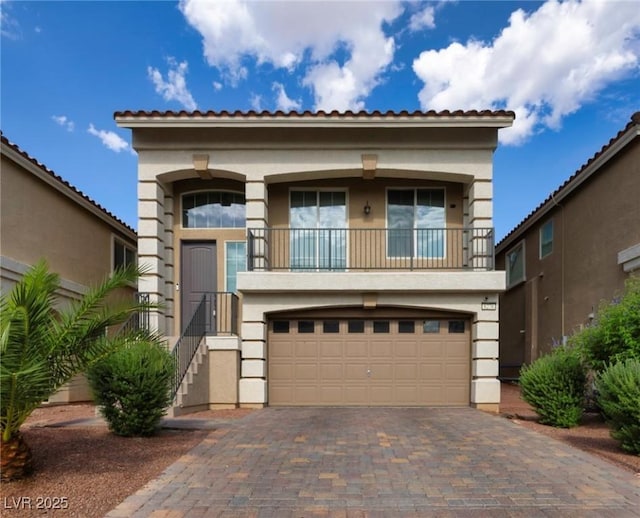 8276 Sorrel St, Las Vegas, NV 89139 - view of front of property featuring a balcony, a garage, stucco siding, and driveway