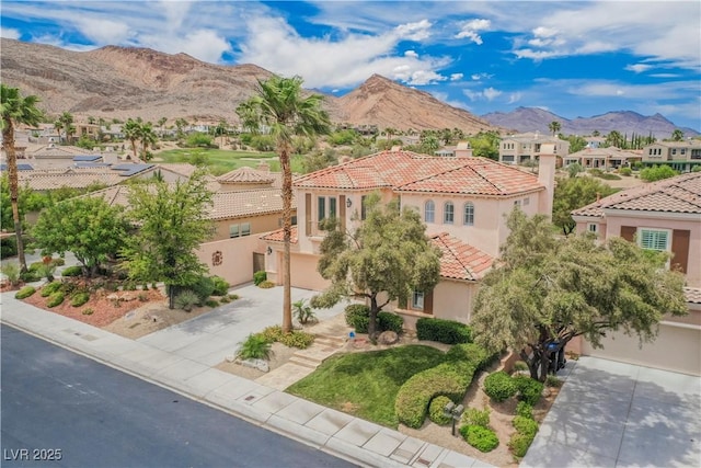 11534 Glowing Sunset Ln, Las Vegas, NV 89135 - mediterranean / spanish-style home featuring concrete driveway, stucco siding, a residential view, a mountain view, and a tiled roof