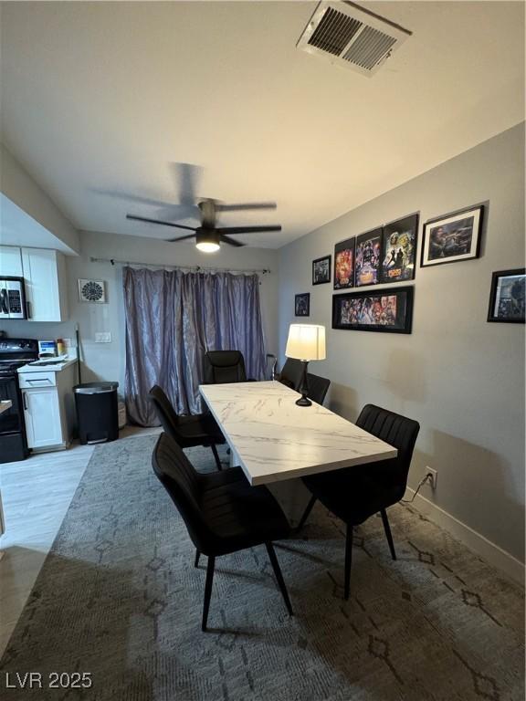 dining space featuring visible vents, a ceiling fan, and baseboards