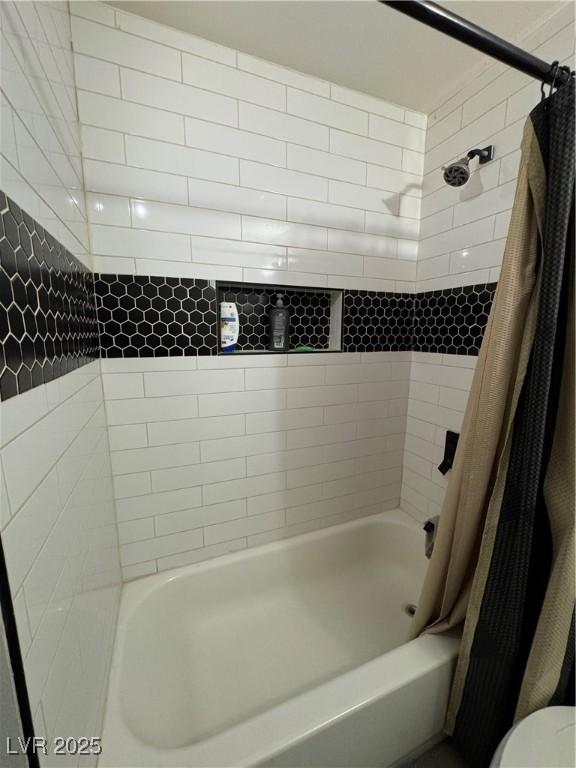 full bath with toilet and shower / bath combo with shower curtain