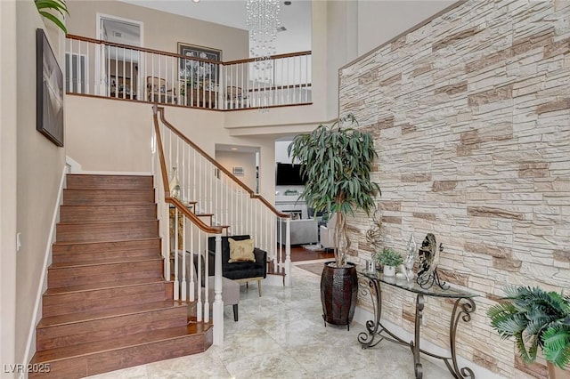 stairs featuring a towering ceiling