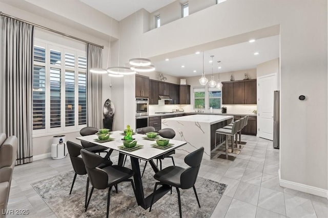 10018 Regency Square Ave, Las Vegas, NV 89148 - dining area featuring light marble finish flooring, recessed lighting, and a towering ceiling