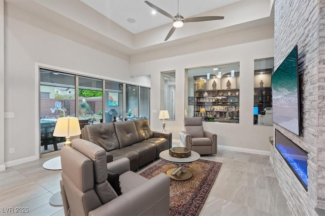 10018 Regency Square Ave, Las Vegas, NV 89148 - living room with a stone fireplace, ceiling fan, and a high ceiling