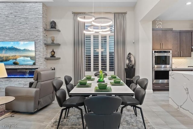 10018 Regency Square Ave, Las Vegas, NV 89148 - dining space with a chandelier and a glass covered fireplace