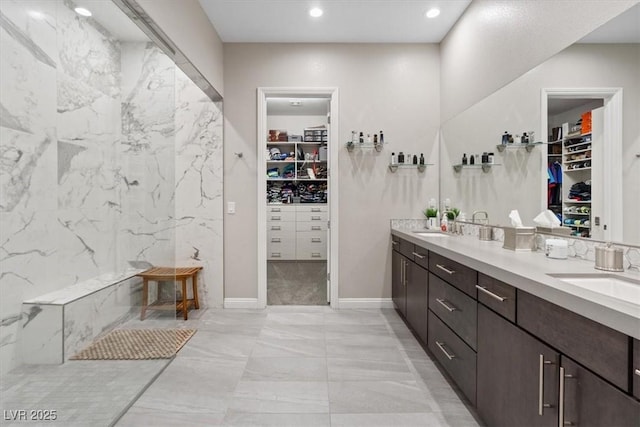 10018 Regency Square Ave, Las Vegas, NV 89148 - bathroom with marble look tiles, double vanity, a spacious closet, and recessed lighting