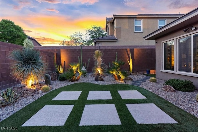 10018 Regency Square Ave, Las Vegas, NV 89148 - yard at dusk featuring a fenced backyard