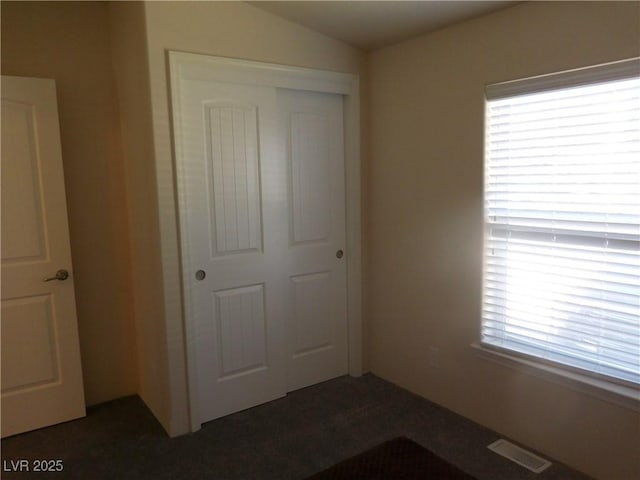 593 Ogden Ave, Ely, NV 89301 - unfurnished bedroom with lofted ceiling, visible vents, and a closet