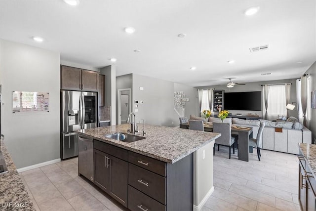 kitchen with a sink, dark brown cabinets, visible vents, ceiling fan, and appliances with stainless steel finishes