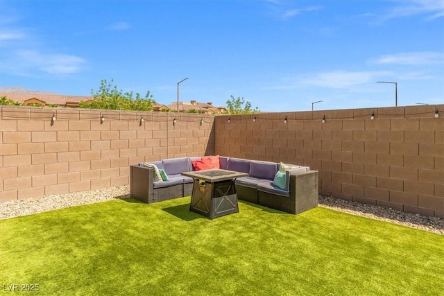 view of yard featuring a fenced backyard and an outdoor living space with a fire pit