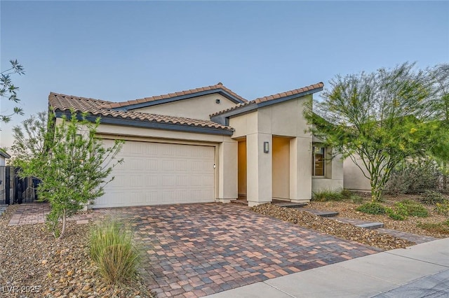 26 Sun Mirage Ave, Henderson, NV 89011 - mediterranean / spanish house with an attached garage, a tile roof, decorative driveway, and stucco siding