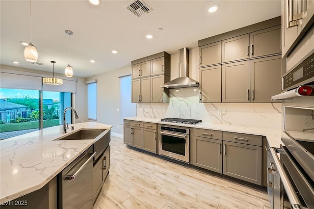 26 Sun Mirage Ave, Henderson, NV 89011 - kitchen with wall chimney range hood, appliances with stainless steel finishes, gray cabinetry, and a sink