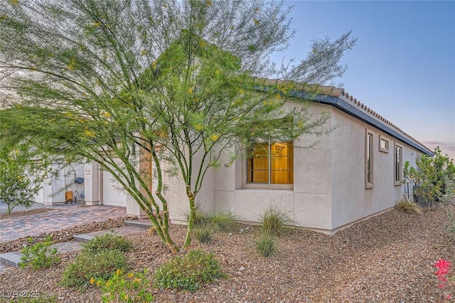 26 Sun Mirage Ave, Henderson, NV 89011 - view of home's exterior with a tile roof and stucco siding