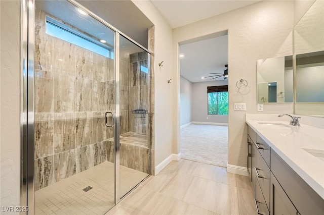 26 Sun Mirage Ave, Henderson, NV 89011 - full bathroom with a sink, double vanity, a stall shower, baseboards, and ceiling fan
