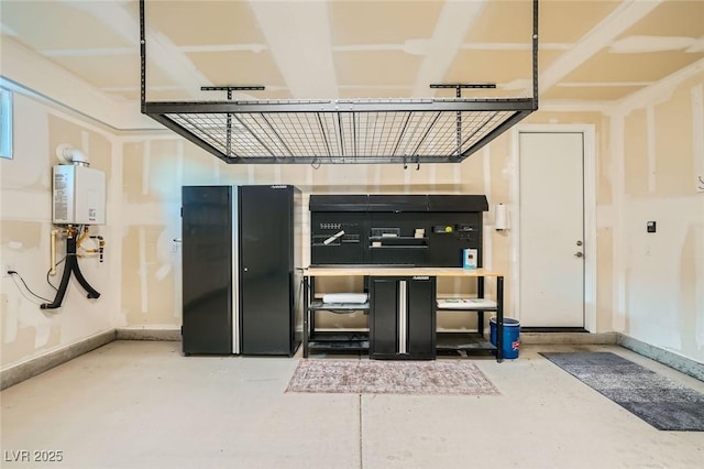 26 Sun Mirage Ave, Henderson, NV 89011 - garage with water heater, freestanding refrigerator, and baseboards