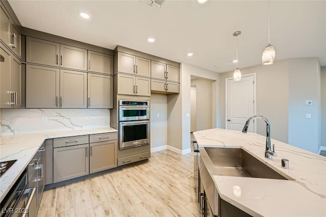 26 Sun Mirage Ave, Henderson, NV 89011 - kitchen featuring baseboards, decorative light fixtures, gray cabinetry, and double oven