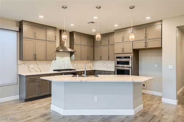 26 Sun Mirage Ave, Henderson, NV 89011 - kitchen with gray cabinets, wall chimney exhaust hood, stainless steel appliances, and light wood-style flooring