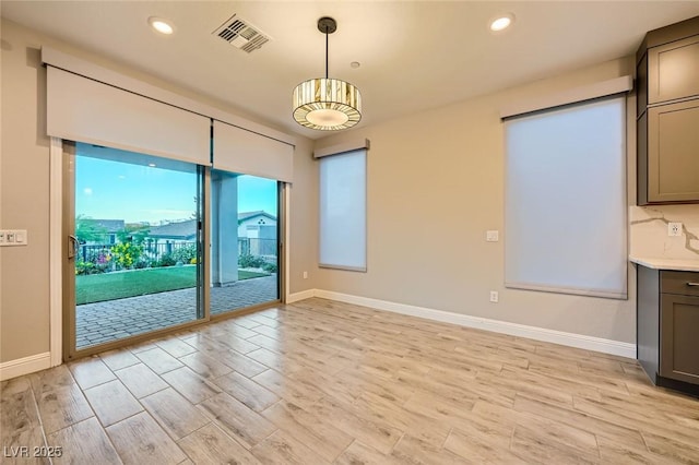 26 Sun Mirage Ave, Henderson, NV 89011 - unfurnished dining area with baseboards, visible vents, and light wood-style floors