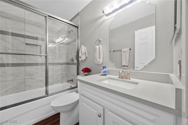 1619 Abby Ave, Henderson, NV 89014 - bathroom featuring vanity, shower / bath combination with glass door, a textured wall, and wood finished floors