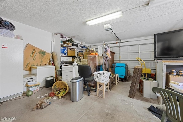 garage with freestanding refrigerator, refrigerator, and a garage door opener