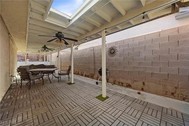 view of patio with outdoor dining space, a fenced backyard, and ceiling fan