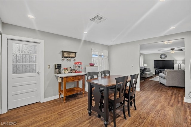 dining room featuring wood finished floors, ceiling fan, baseboards, visible vents, and recessed lighting