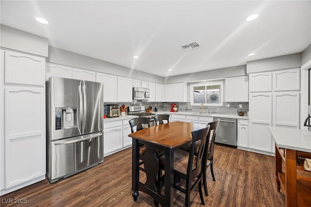 kitchen with light countertops, visible vents, white cabinetry, and appliances with stainless steel finishes