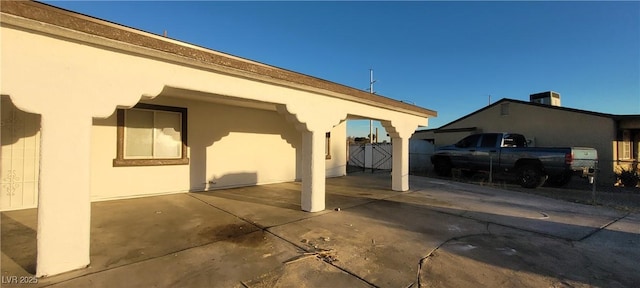 2740 Vita Dr, North Las Vegas, NV 89030 - view of home's exterior featuring stucco siding, fence, central AC, and a patio