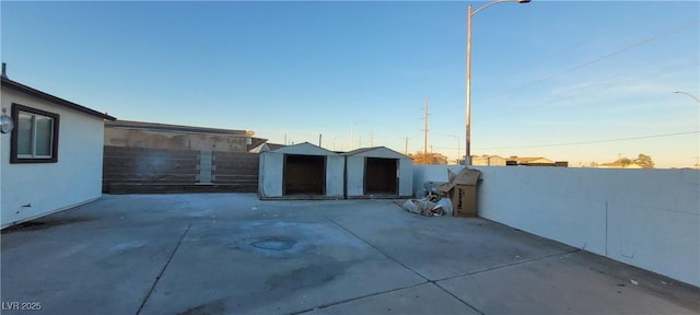 2740 Vita Dr, North Las Vegas, NV 89030 - view of patio with a fenced backyard, an outdoor structure, and a storage unit