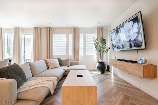 living area featuring baseboards